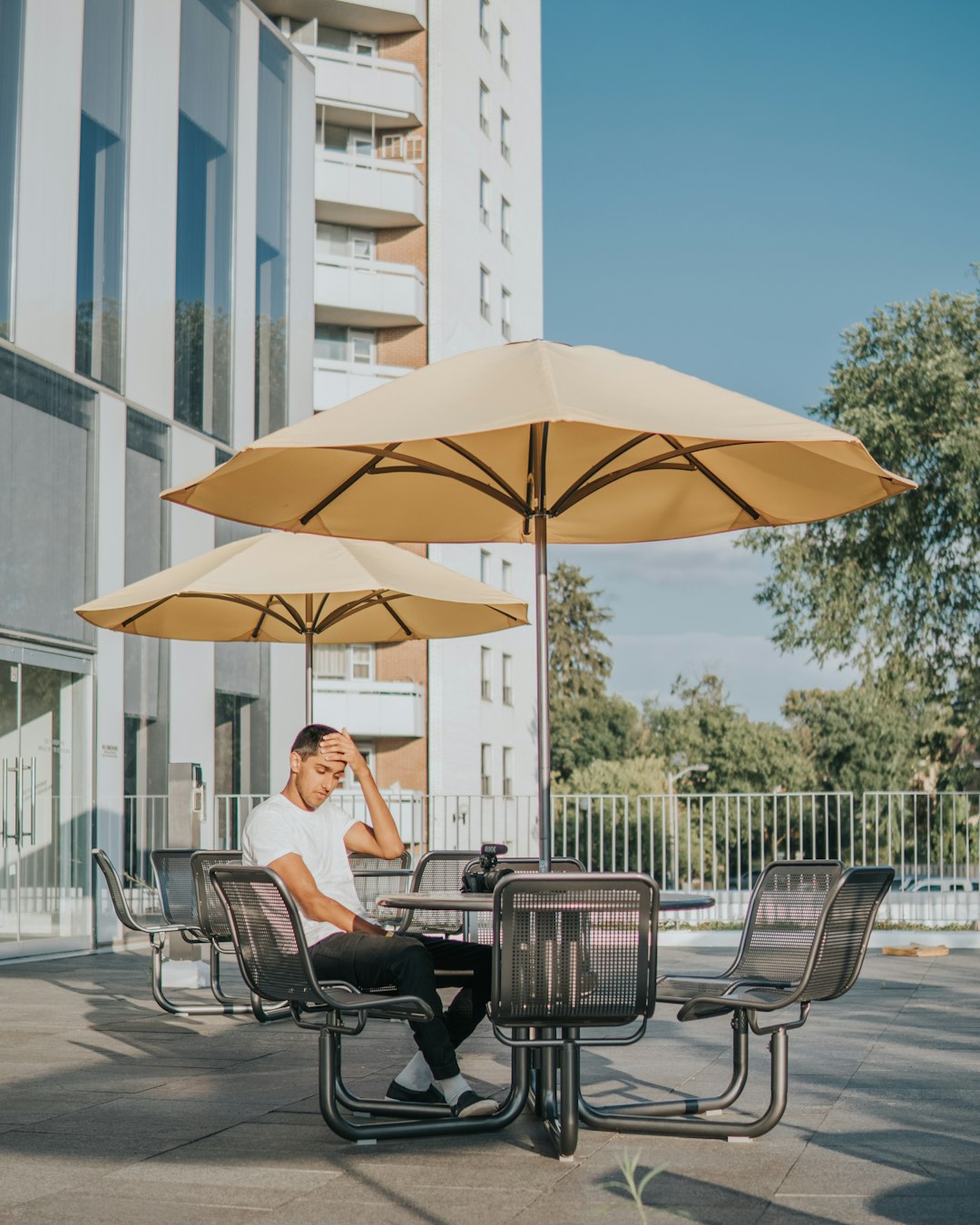 man sitting on black metal chair