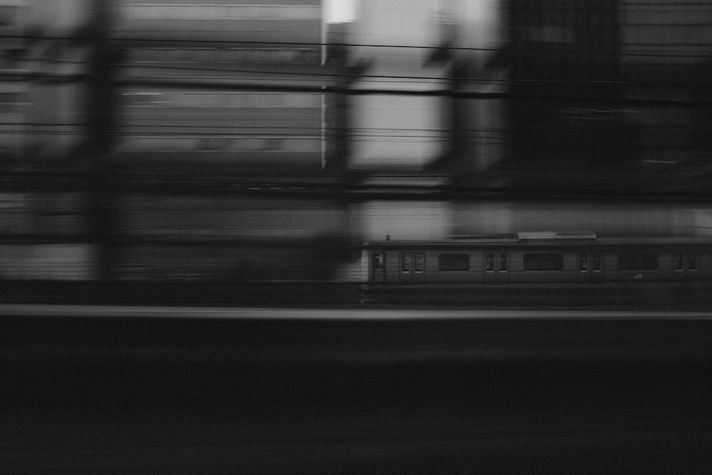 Black and white train moving past in a blur in Tokyo