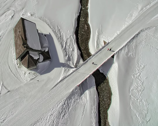 snow-covered flooring near house at daytime in Melchsee-Frutt Switzerland