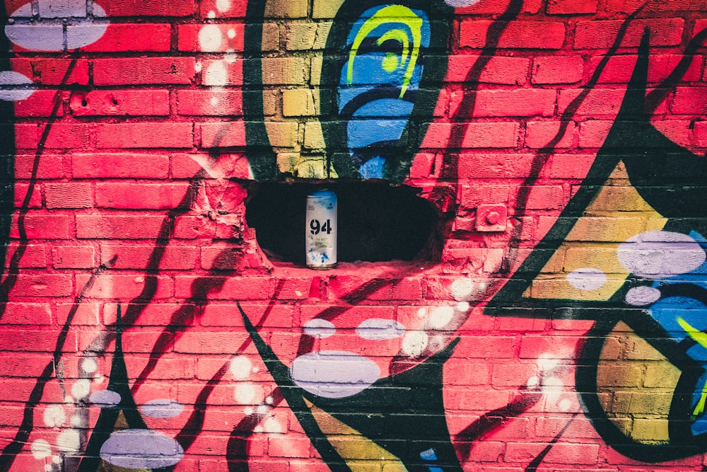 white and blue can in graffiti