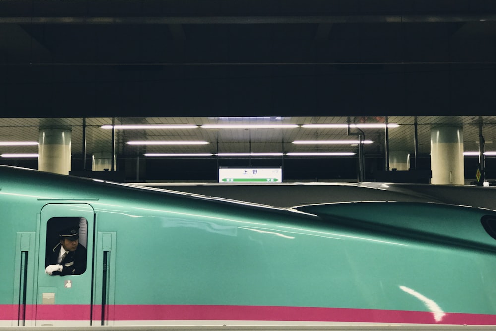 Train conductor looks for passengers outside a metro window