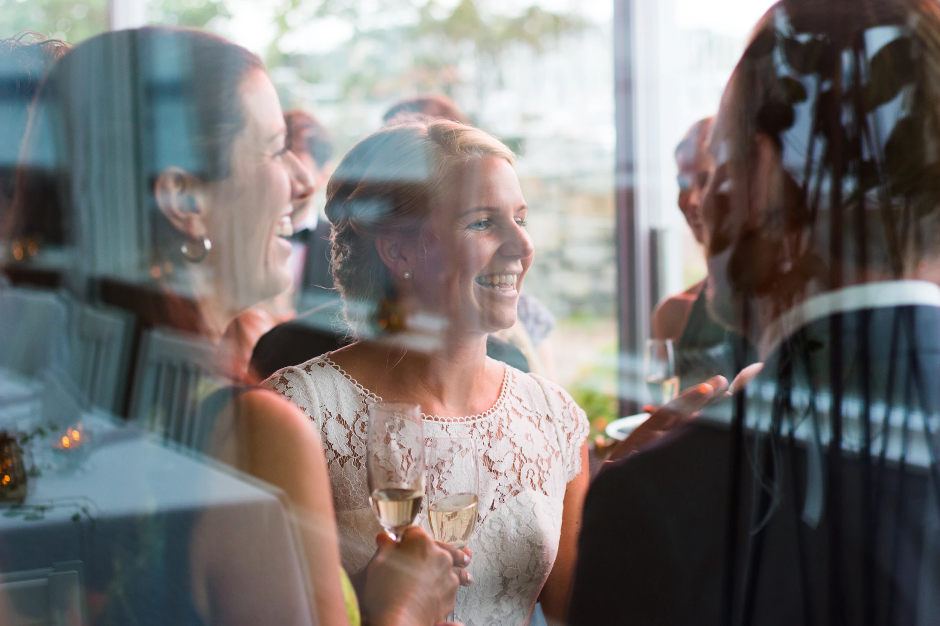 A stylish group of VIP guests laughing and connecting during the exclusive evening dedicated to mind, body, and soul care.
