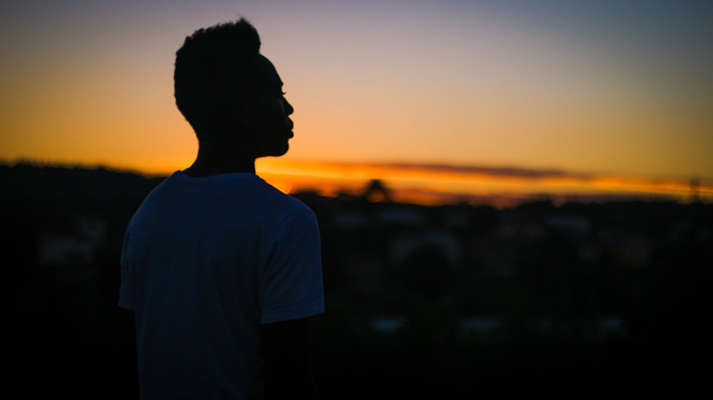 silhouette of man in white shirt