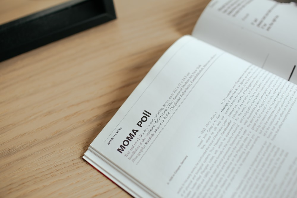 an open book sitting on top of a wooden table