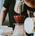 person holding stainless steel pitcher