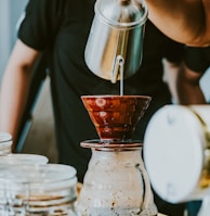 person holding stainless steel pitcher