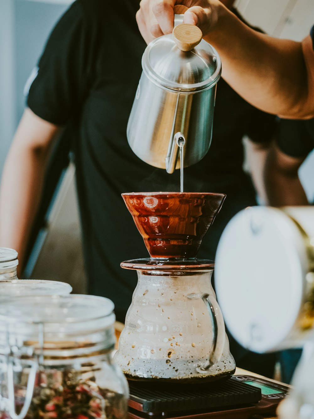 person holding stainless steel pitcher