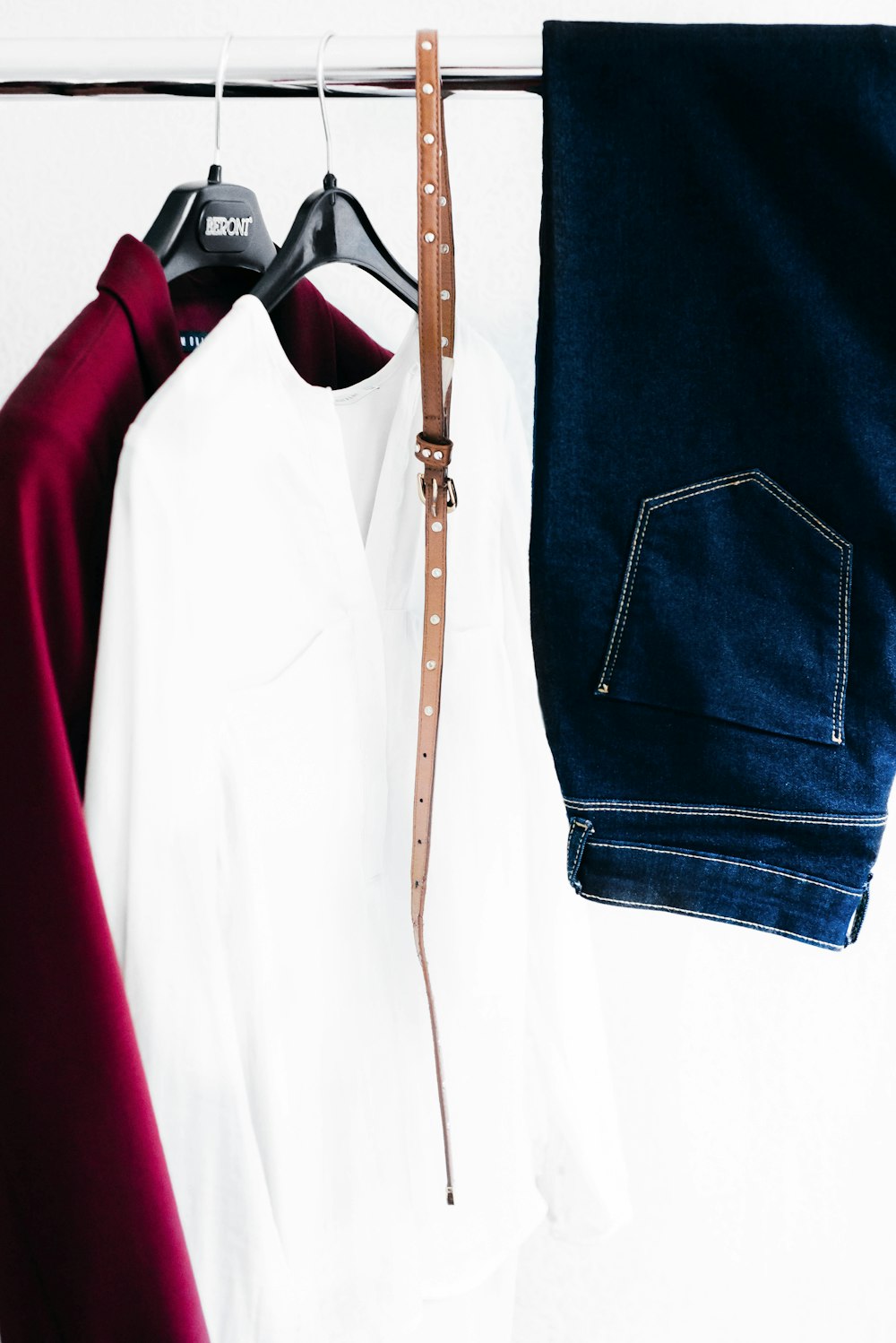two white and red long-sleeved shirt with belt and jeans