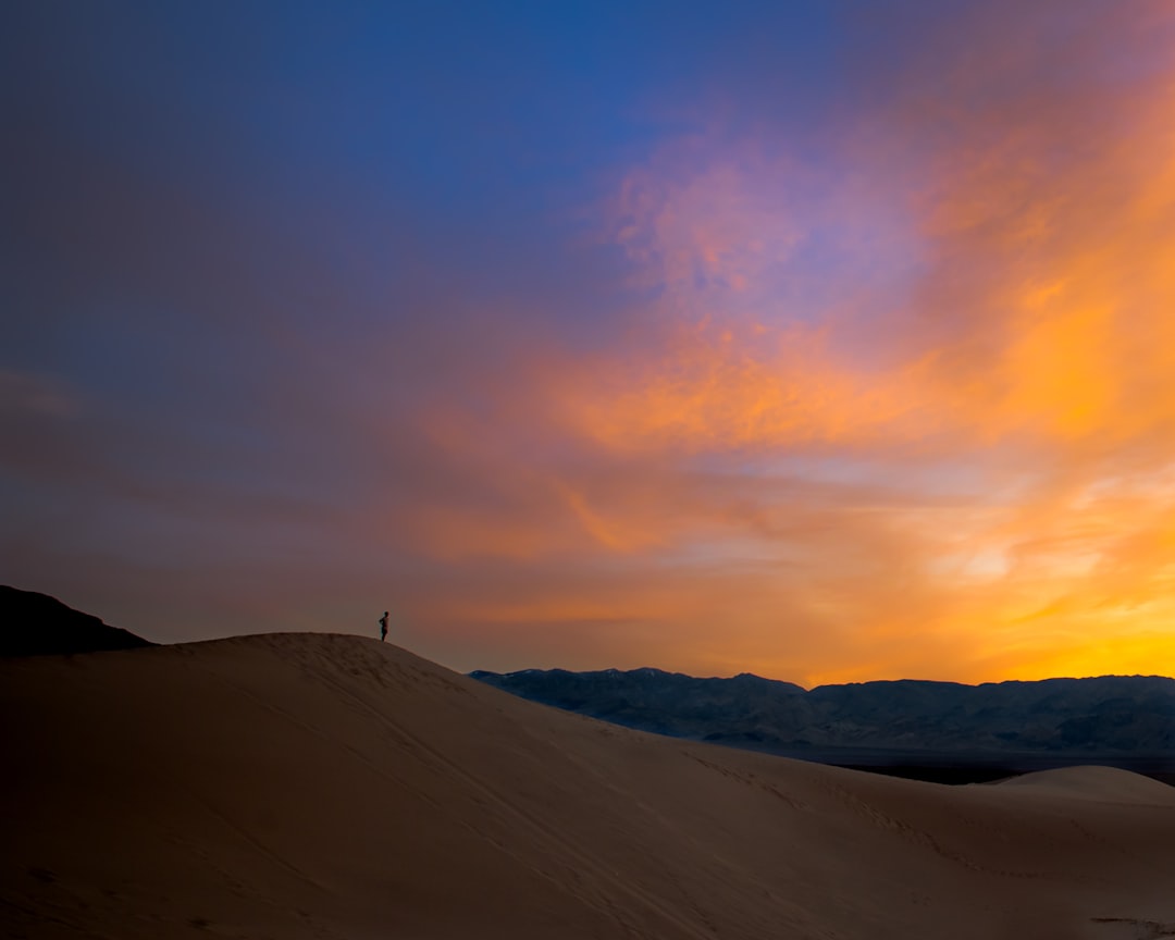 silhouette of person standing on mountain, Sunset on the dunes in Death Valley NP