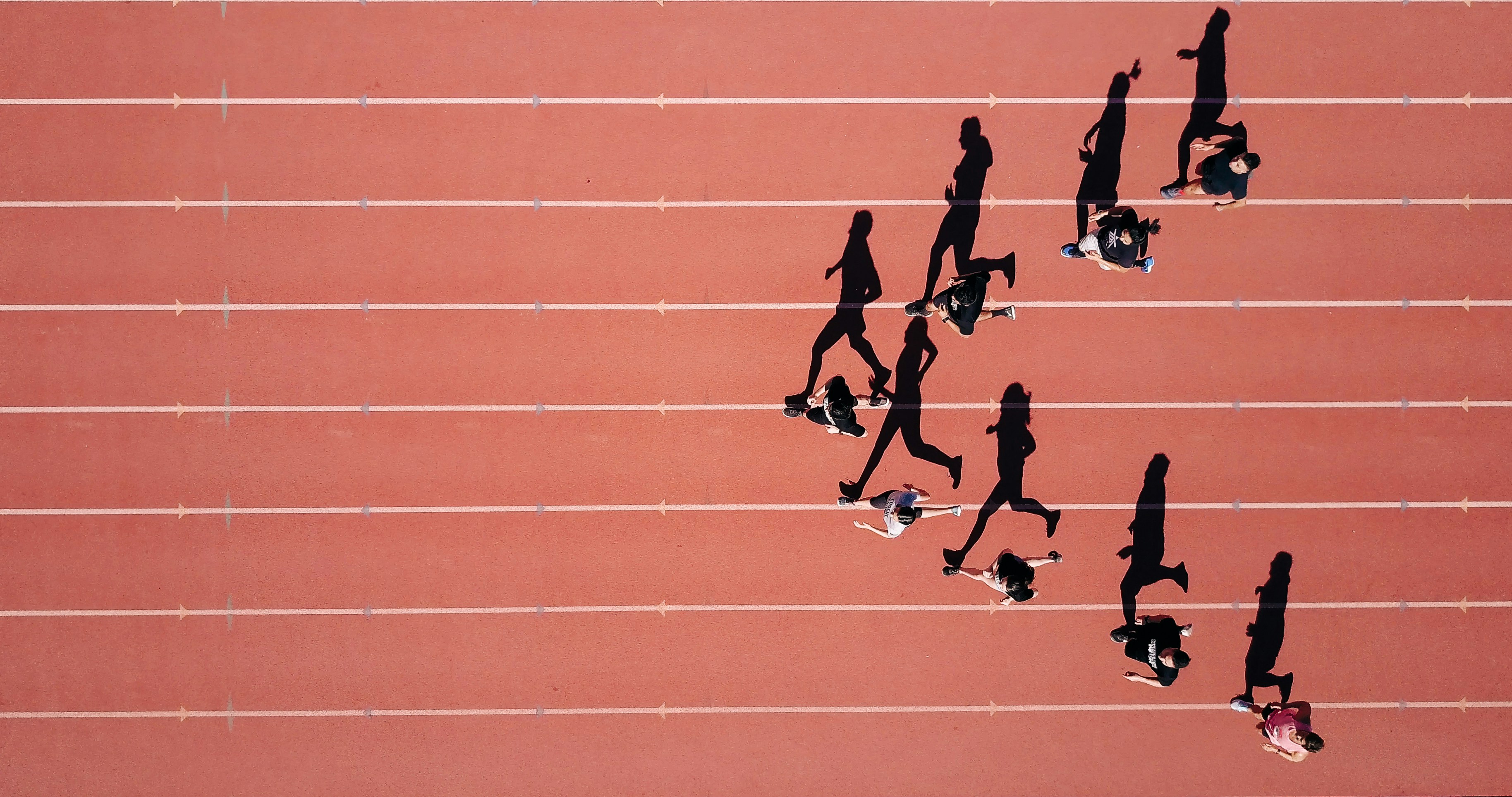 Working on a project for my school’s track team on a summer morning. I noticed the sun was perfectly angled to expand the shadows of the runners into full size. I launched my Mavic Pro to 300 ft. and made them run in arrow shape.\r \r Which I was able to capture this interesting overhead shot of them running and their shadows be an identical profile shot of them.