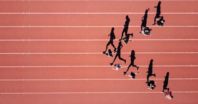 group of people running on stadium sport teams background