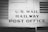 The image features a vintage railway car with the words 'U.S. Mail Railway Post Office' prominently displayed. The surface is metallic and riveted, suggesting an industrial design from the early to mid-20th century. The image is in black and white, enhancing its historical feel.