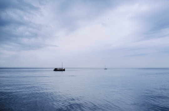 boat on sea under white clouds during daytime in Piran Slovenia