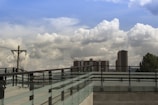 A newly built roof deck with sturdy railings overlooking a cityscape.