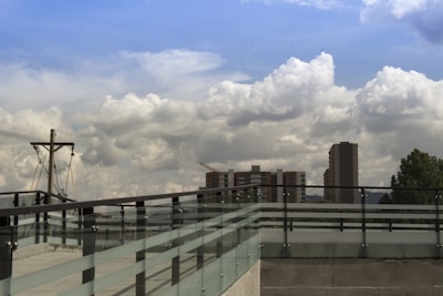 A newly built roof deck with sturdy railings overlooking a cityscape.