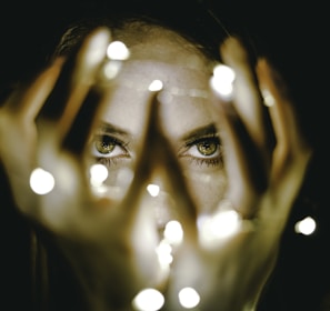 woman holding string lights