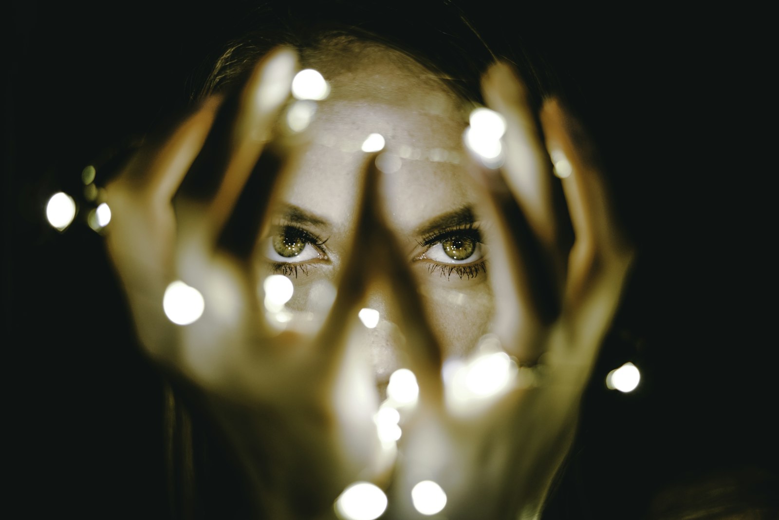 Sony a7R II + Sony FE 50mm F1.8 sample photo. Woman holding string lights photography