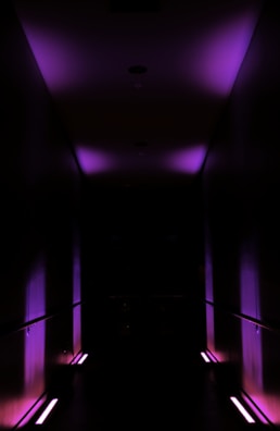 Digital hallway corridor with deep blue and purple gradient walls glowing softly.