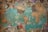 A vintage world map covered with various international currency notes serves as a background. Colorful pins are densely clustered over some regions, indicating highlighted areas. The currencies range from dollars to euros and others, scattered across the edges, giving a sense of travel or exploration.