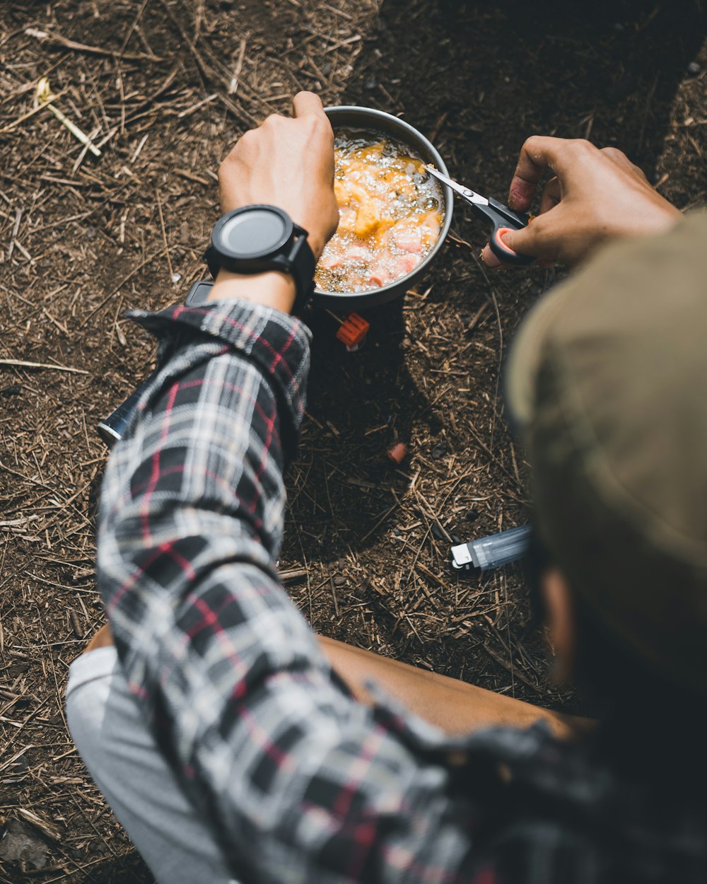 person cooking on stainless steel bowl