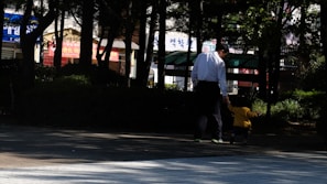 A father and son walking in the park wearing matching casual solelegend outfits.