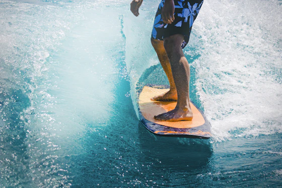 Stand-up paddleboarder and kayaker sharing a calm bay at golden hour