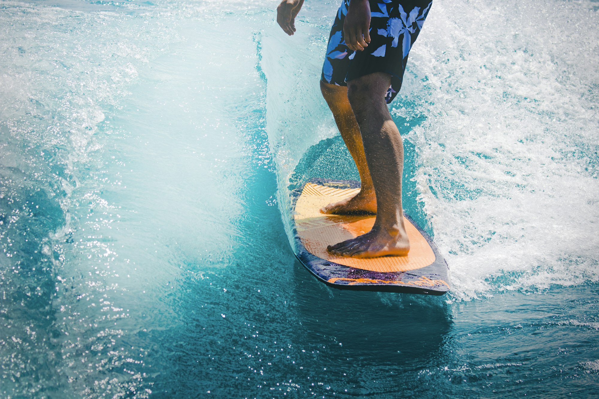 Surfer riding a powerful wave at golden hour