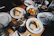 A neatly arranged catering spread with sandwiches, salads, and beverages on a conference table.
