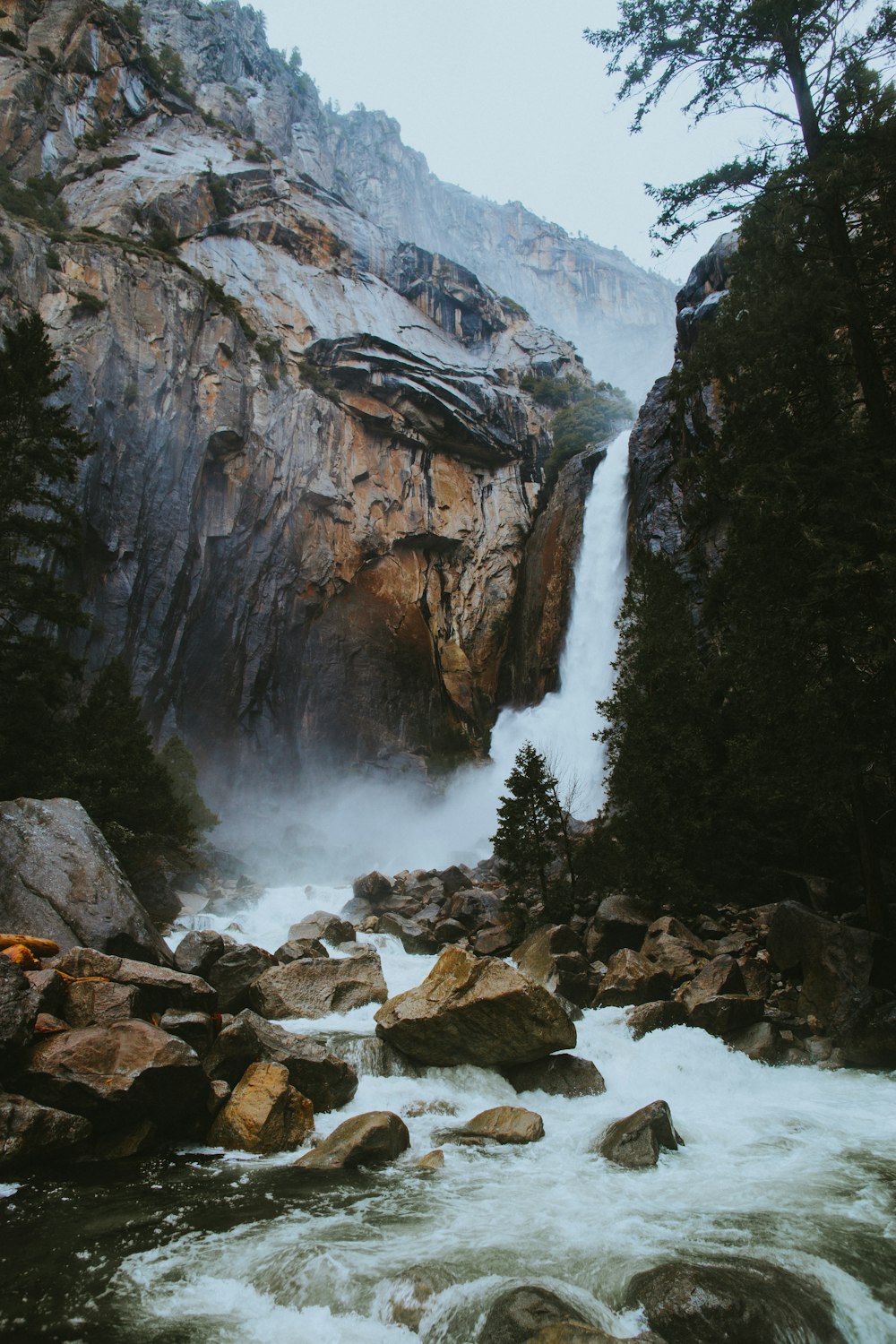 river stream between rocks during daytime