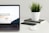 MacBook Pro near green potted plant on table