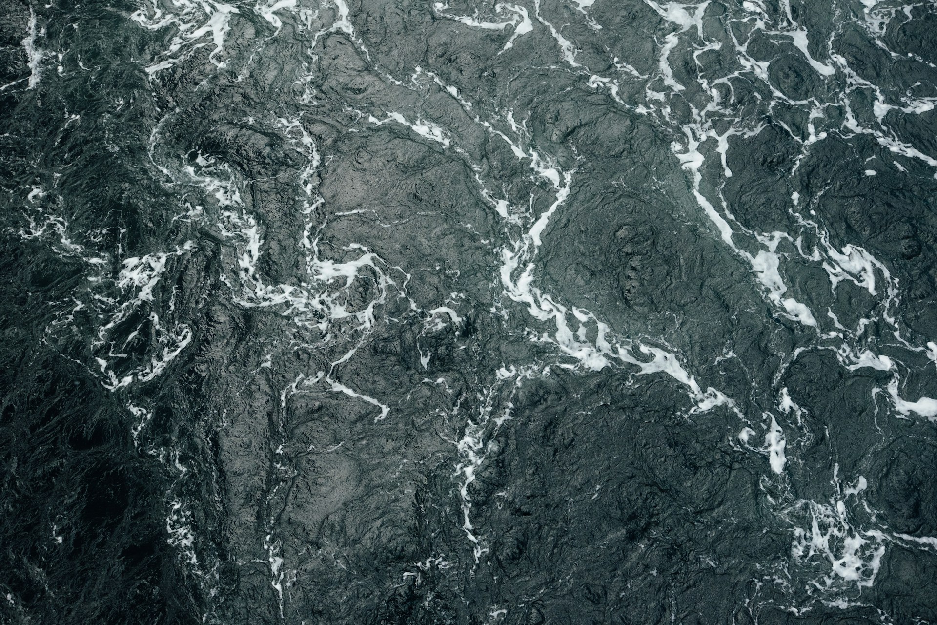 A drone shot of the choppy surface of the sea
