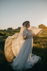 woman wearing wedding gown in green grass field