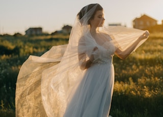 woman wearing wedding gown in green grass field