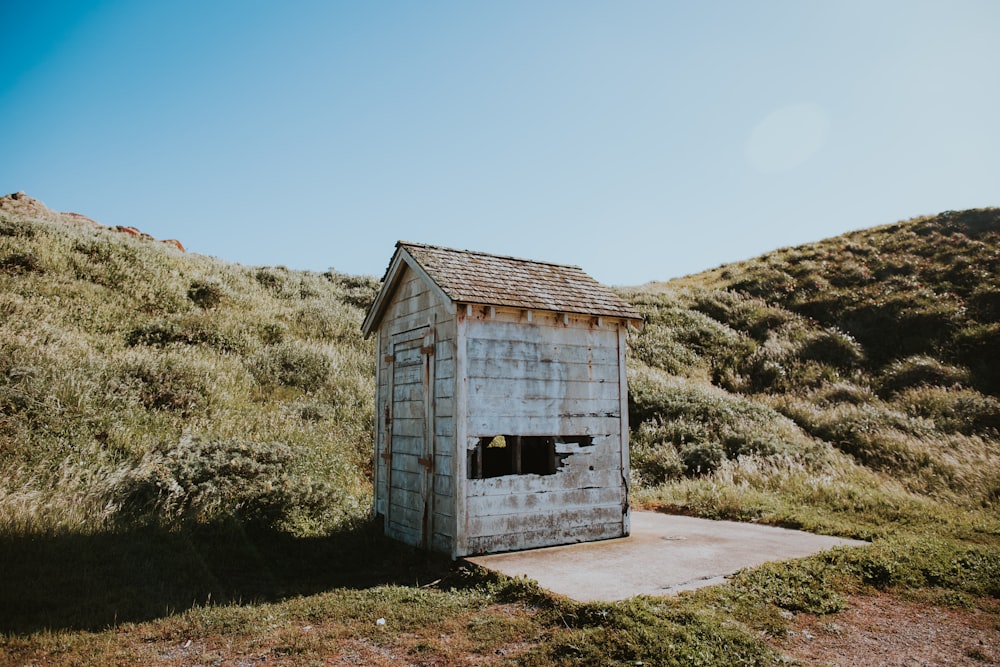 shed on grass field under cumulus clouds