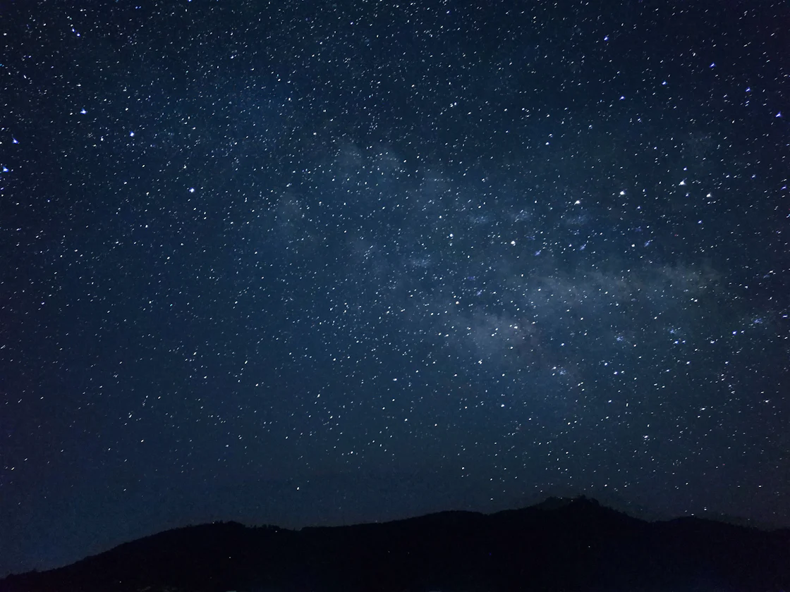 The night sky filled with stars above a mountain silhouette, evoking Astro's celestial namesake and the framework's ambition to power the web's content layer.