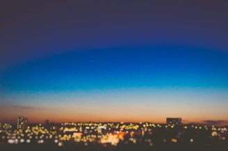 A softly glowing countdown timer overlayed on a blurred cityscape at dusk.