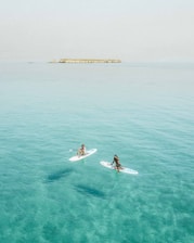 Guests enjoying paddleboarding and snorkeling in calm, turquoise waters near Marbella.