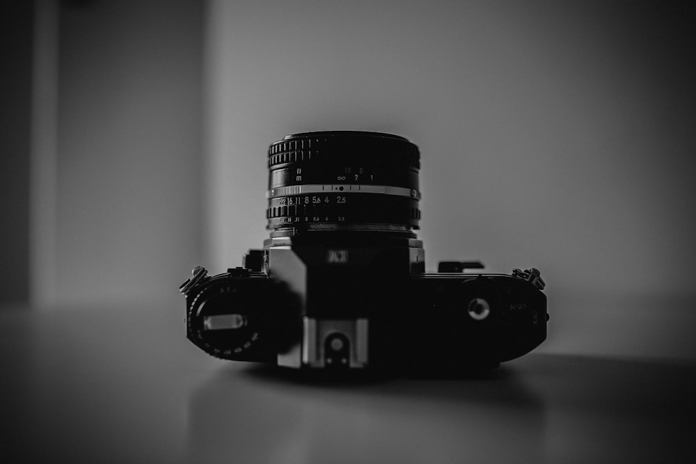 black and gray DSLR camera on table