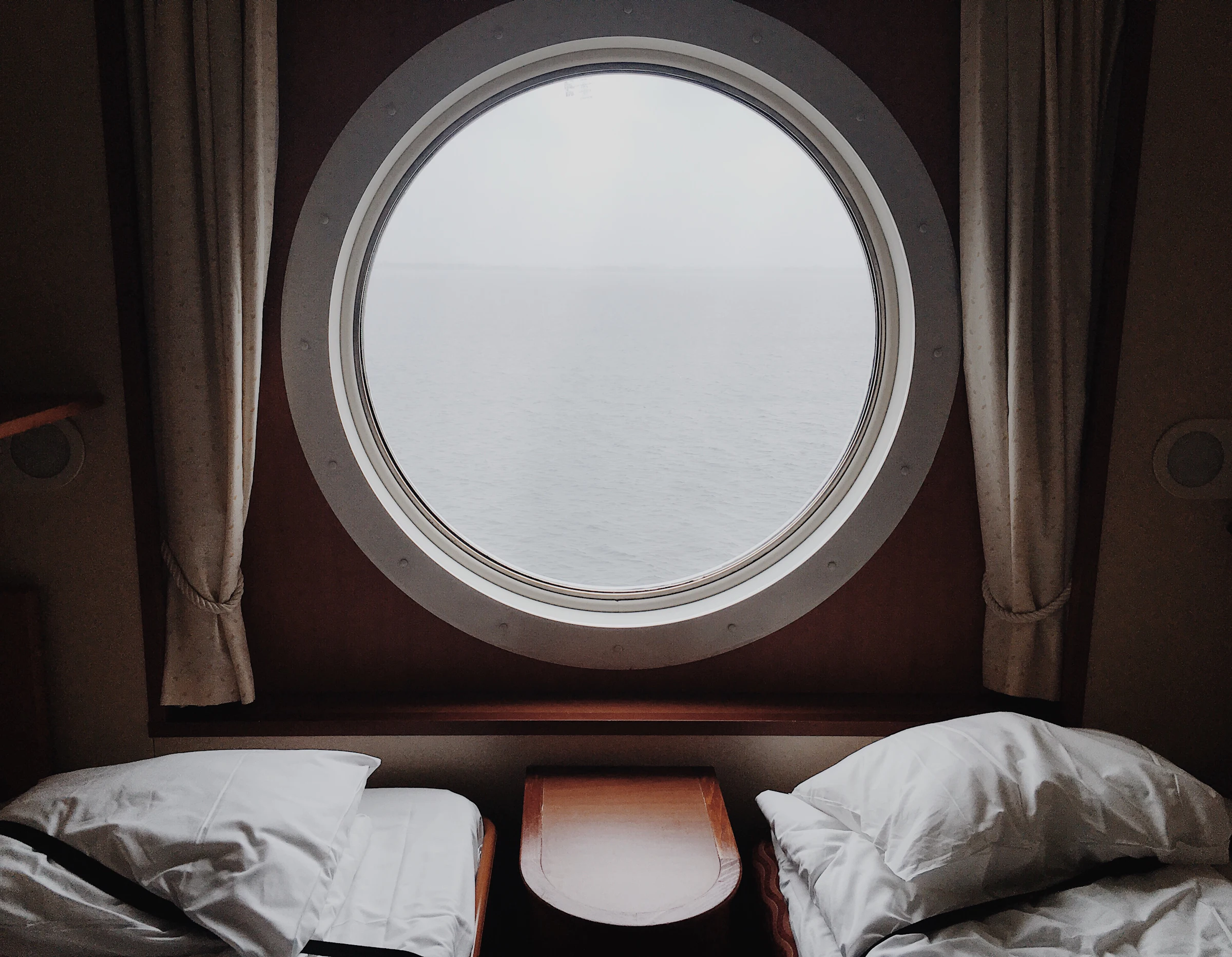 Daylight through a porthole in a yacht cabin