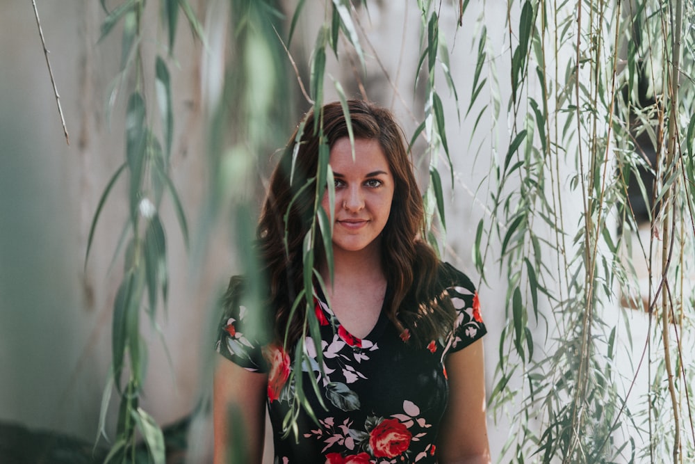 woman wearing floral shirt hiding on leaf