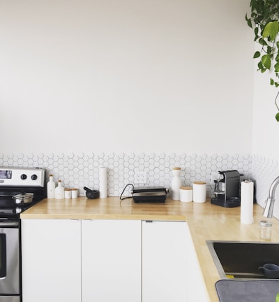 black coffee maker on brown wooden kitchen table