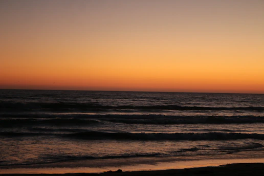 A serene ocean horizon at sunset framed within a minimalist website layout.
