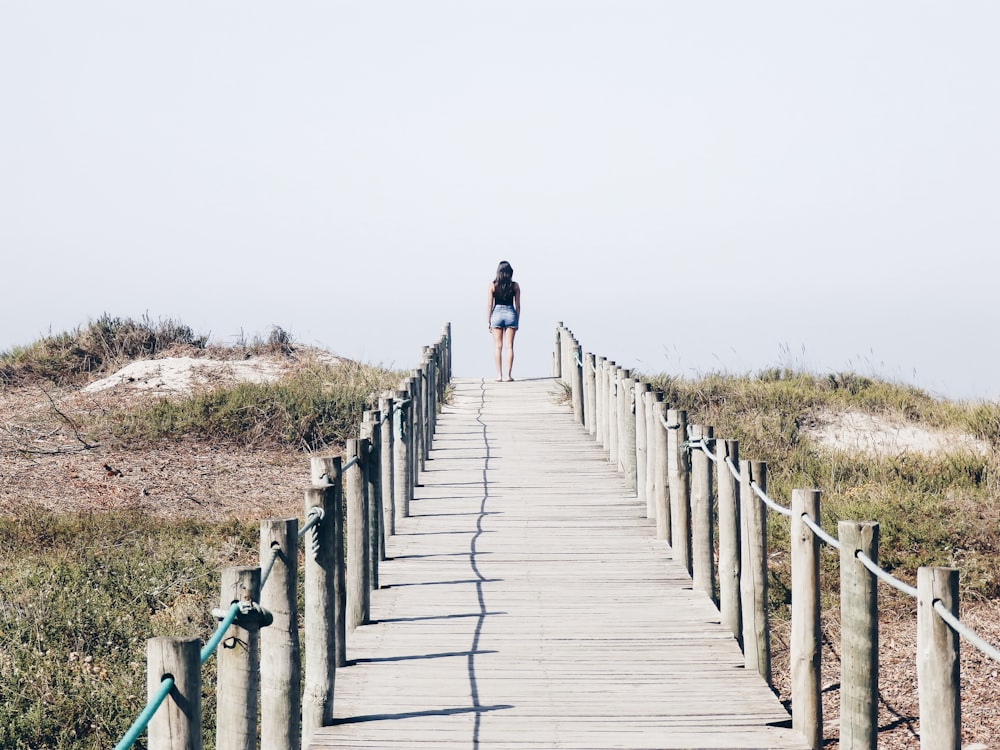 woman standing on the edge of the bridge