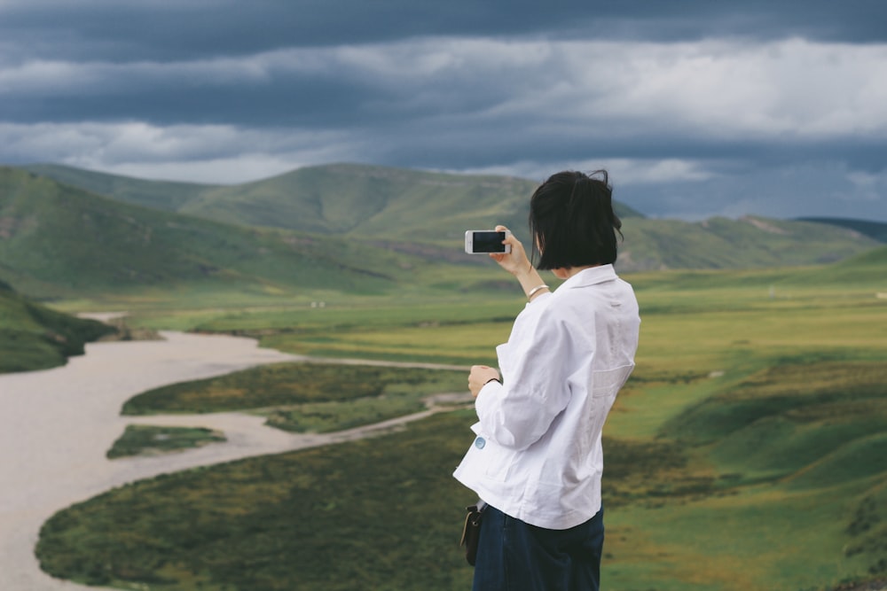 woman taking a photo of mountain