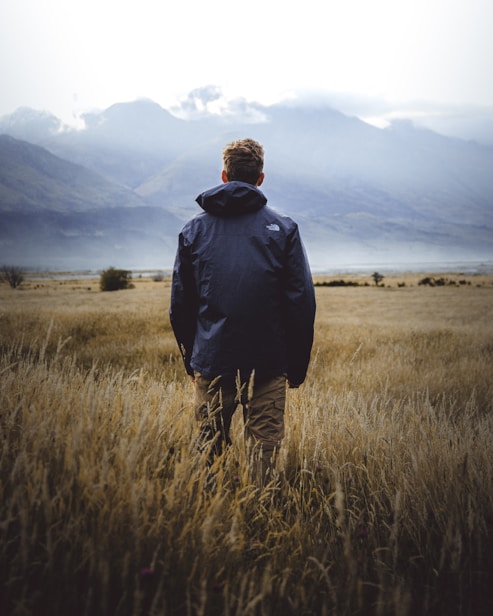 man in middle of wheat field