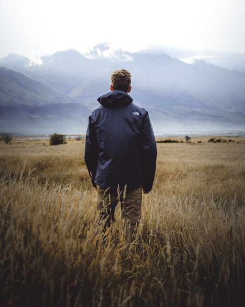 man in middle of wheat field