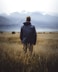 man in middle of wheat field