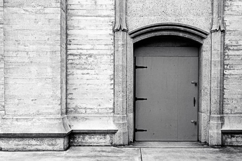 a black and white photo of a door to a building