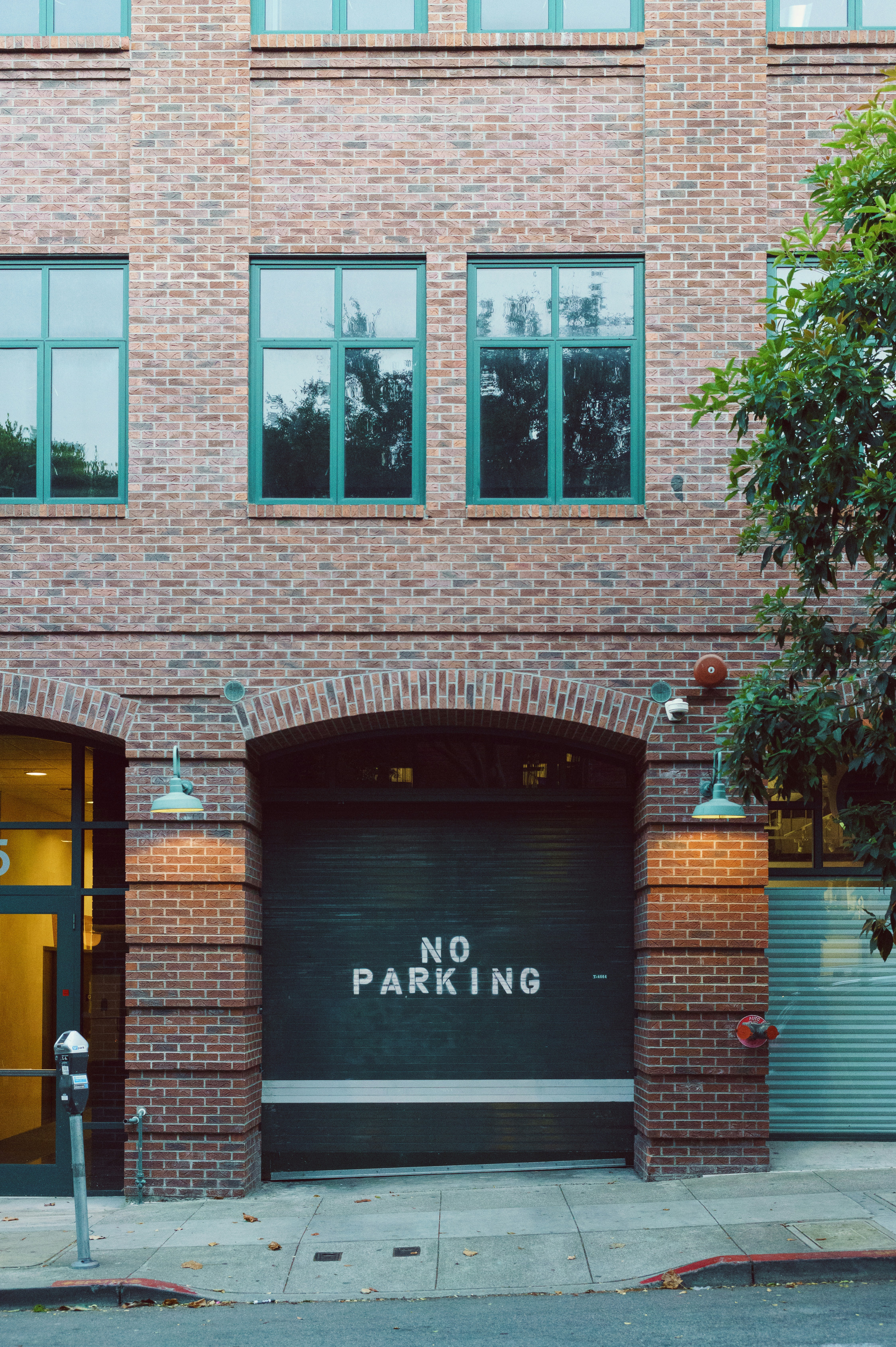 A brick building with a no parking sign on it