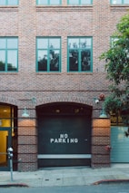 a brick building with a no parking sign on it